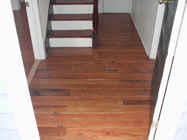 Refinished heart-pine hallway looking back to the staircase.