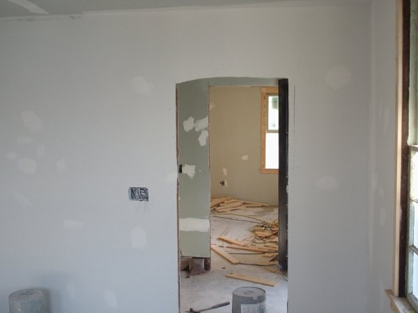 Original arched plaster doorway re-framed in drywall.